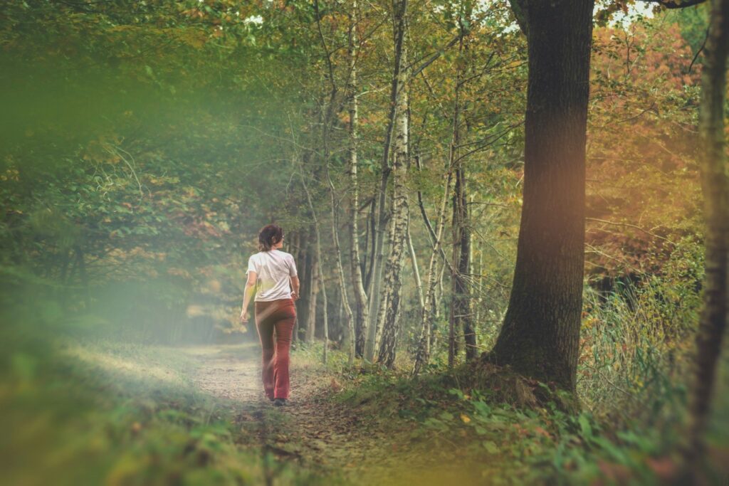 woman walking through forest
